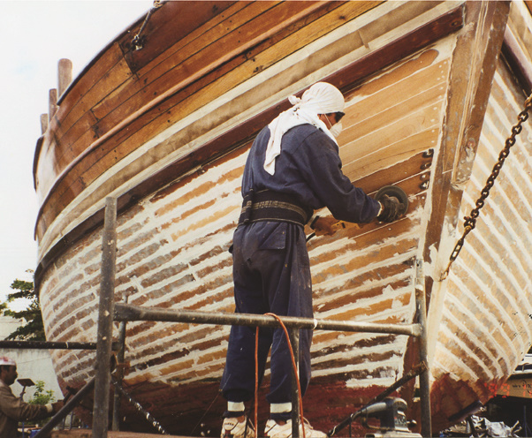 Grinding a wooden boat